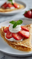 Strawberry crepe with whipped cream and fresh mint leaf on white plate, delicious breakfast or dessert treat