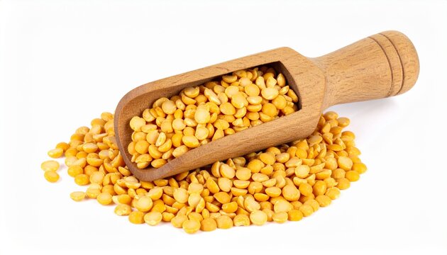 Plump and round yellow split peas in a wooden scoop against white background