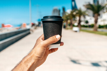 Takeaway Coffee on a Sunny Seaside Boulevard
