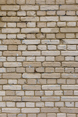 Fototapeta premium A boring wall of gray silicate bricks. Neutral building background of degradation.