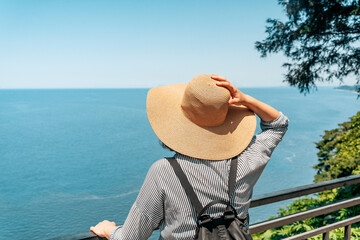 Female Explorer Looking at Ocean Horizon from Cliff