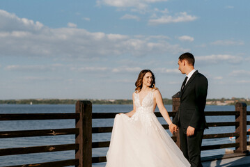 bride and groom walking in the park