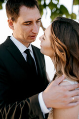 bride and groom walking in the park
