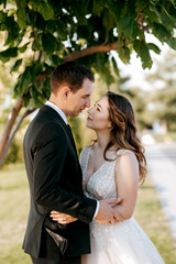 bride and groom walking in the park