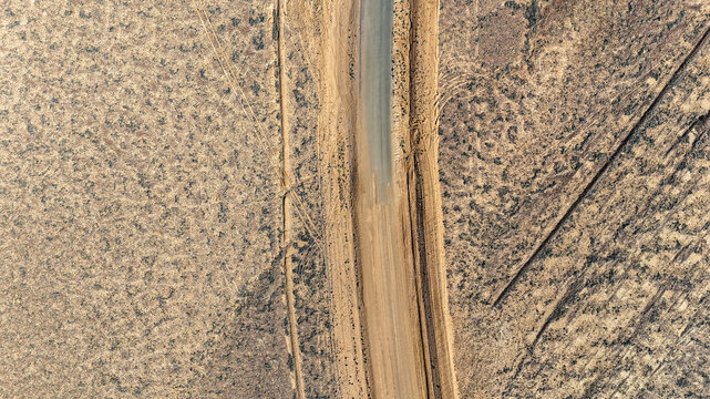 Aerial of where the dirt road meets the tar - sealed to unsealed road
