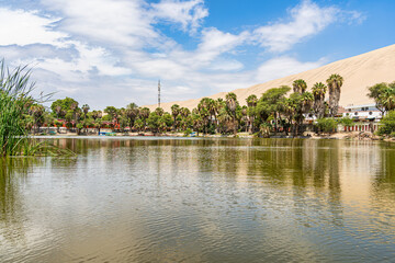 Fototapeta premium View of the Huacachina Oasis lagoon and the sand dunes in Ica, Peru
