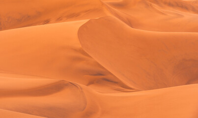 Ica desert landscape with smooth golden sand dunes near Huacachina, Peru.