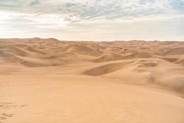 Ica desert landscape with smooth golden sand dunes near Huacachina, Peru.
