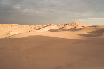Golden sunset over the vast dunes of the Ica Desert near Huacachina, Peru.