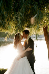 bride and groom walking in the park