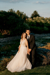 bride and groom walking in the park