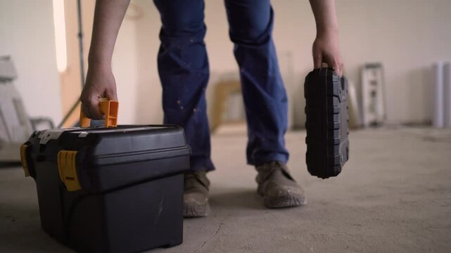 Repairman or workman holding toolbox walk in construction ready for repairing apartment