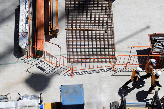Overhead view of a construction site with construction workers having a meeting