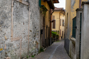 Ancient stone arches, weathered walls, medieval charm, Italian old town atmosphere, timeless travel destination region Piedmont, Old European district
