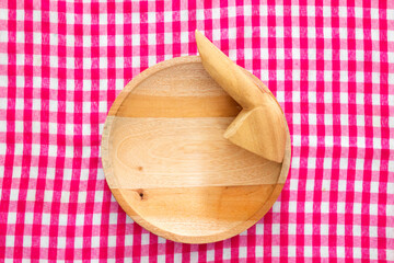 Wooden mortar with red checkered tablecloth background