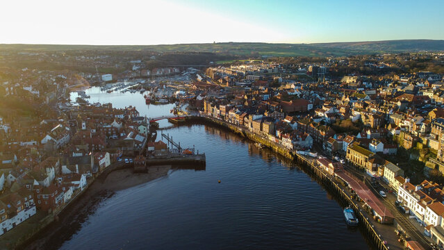 Aerial view of Whitby, showcasing the town nestled along the winding River Esk