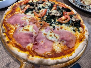 A delicious half & half pizza featuring classic parma ham on one side and creamy spinach cheese with shrimp on the other. Freshly baked with golden melted cheese and crispy crust – perfe