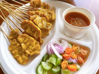  Charcoal-grilled pork satay served with rich peanut sauce and Thai-style cucumber relish. A beloved classic in Thai street food.