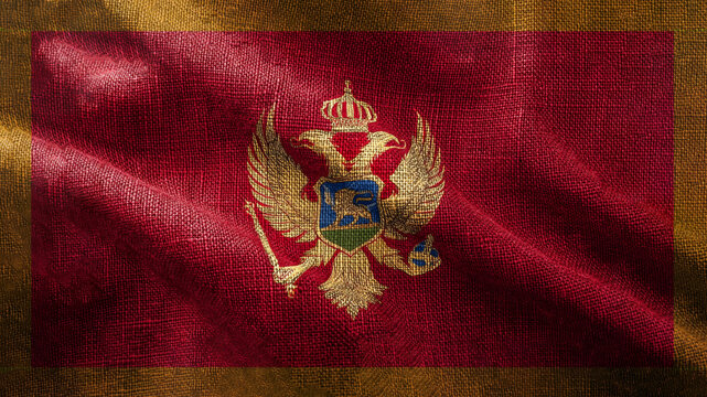 Silk flag of Montenegro displays rich red and gold hues, showcasing the intricate coat of arms with a crowned double-headed eagle.