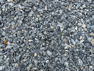 black and white pebbles,Black gravel surface of the road surface.