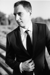 portrait of a young bearded guy groom on a water