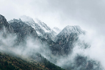 a mountain covered in snow and clouds