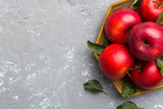 Many red apples on colored background, top view. Autumn pattern with fresh apple above view with copy space for design or text