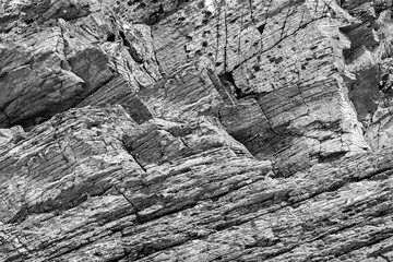 A large rock formation closeup in black and white monochrome