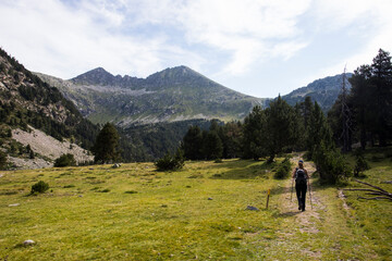 Fototapeta premium Young hiker woman in Vall de Boi, Aiguestortes and Sant Maurici National Park, Spain