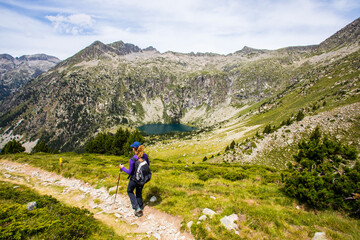 Obraz premium Young hiker woman in Vall de Boi, Aiguestortes and Sant Maurici National Park, Spain