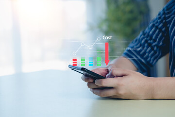 Business pointing down arrow of the graph with cost reduction business finance on virtual screen. Cost reduction concept.