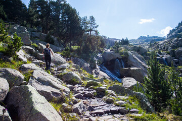 Young hiker woman in Vall de Boi, Aiguestortes and Sant Maurici National Park, Spain