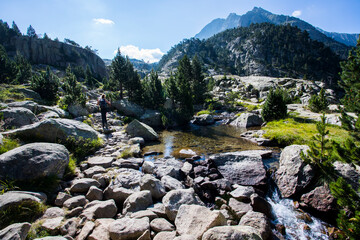 Young hiker woman in Vall de Boi, Aiguestortes and Sant Maurici National Park, Spain