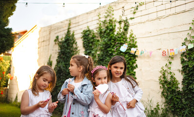 Joyful sisters celebrate together in a sunny garden