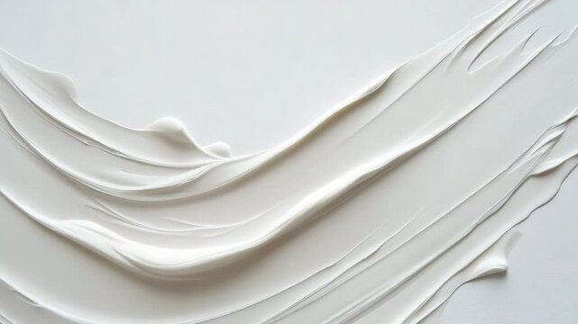 A white line of cream is drawn on a white background. The line is curvy and has a sense of movement. The cream appears to be flowing, as if it is being applied to a surface