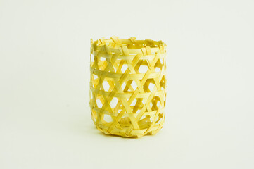 Small wicker bamboo basket isolated on white background.