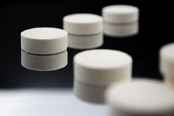 white pills on black background