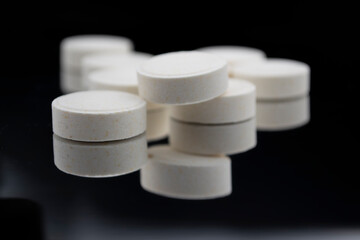 white pills on black background