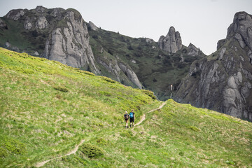 Carpathian mountain landscape with hiking road towards high cliffs 