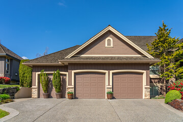 Garage door in luxury house with trees and nice landscape in Spring in Vancouver, Canada, North...