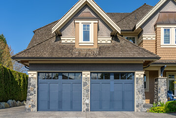 Garage door in luxury house with trees and nice landscape in Spring in Vancouver, Canada, North...