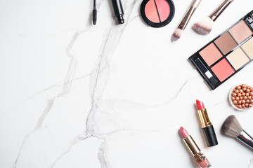 Make up products at white marble background.