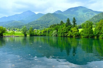 View of Črnava lake near Preddvor and the mountains above in the summer in Gorenjska, Slovenia