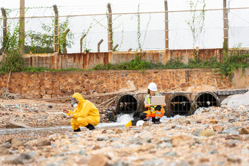 Workers Collecting Water Samples for Environmental Research, Engineers Analyzing Environmental Data on a Beach Cleanup Project, Environmental Engineers Conducting Field Work for Pollution Control