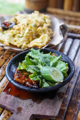 Sambal Gami, Indonesia, captured on June 9, 2025. Traditional spicy chili sauce served on a hot clay plate, made with fresh chilies, garlic, tomatoes, and shrimp paste for bold and smoky flavor.