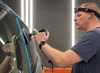 Car detailing series: Polishing grey car close-up. The process of polishing the car body in...