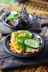 Sambal Gami, Indonesia, captured on June 9, 2025. Traditional spicy chili sauce served on a hot clay plate, made with fresh chilies, garlic, tomatoes, and shrimp paste for bold and smoky flavor.