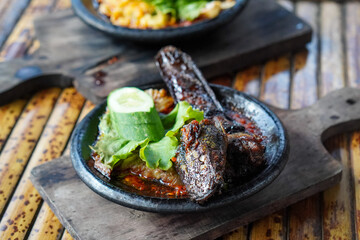 Sambal Gami, Indonesia, captured on June 9, 2025. Traditional spicy chili sauce served on a hot clay plate, made with fresh chilies, garlic, tomatoes, and shrimp paste for bold and smoky flavor.