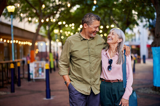 Romantic mature couple looking at each other during evening walk