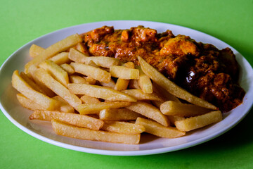  A Plate of Traditional Chicken Tikka Masala With Chips